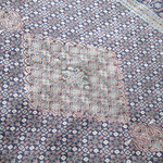 Persian Tabriz rug corner with pale central cartouche and blue floral pattern