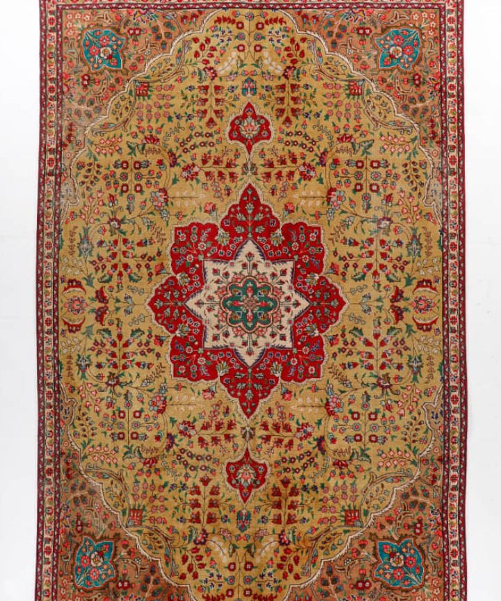 Persian Tabriz style rug with cream base, red center medallion, teal accents, border details.