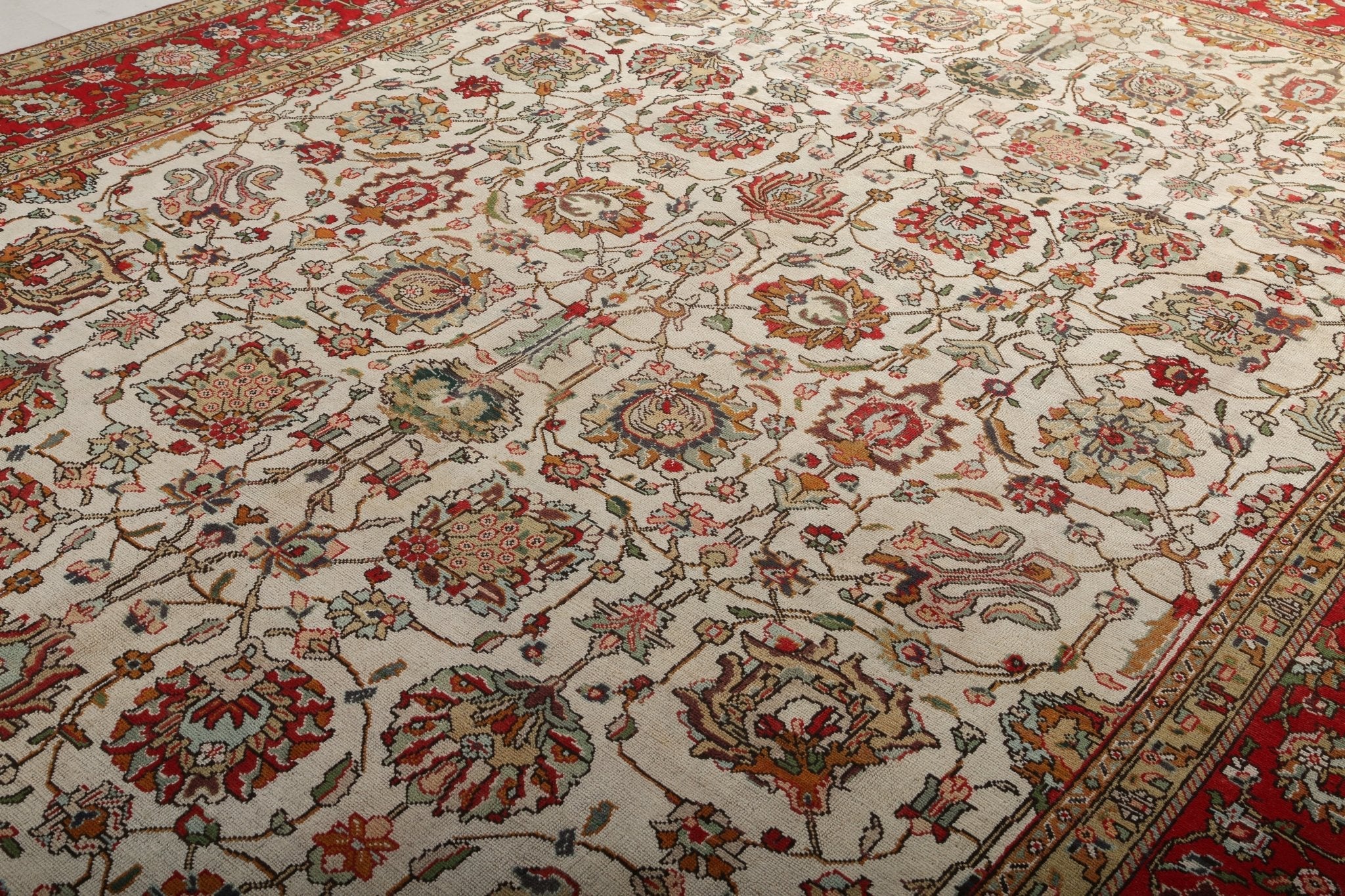 Persian Tabriz rug, cream field with red floral medallions and detailed corner motifs