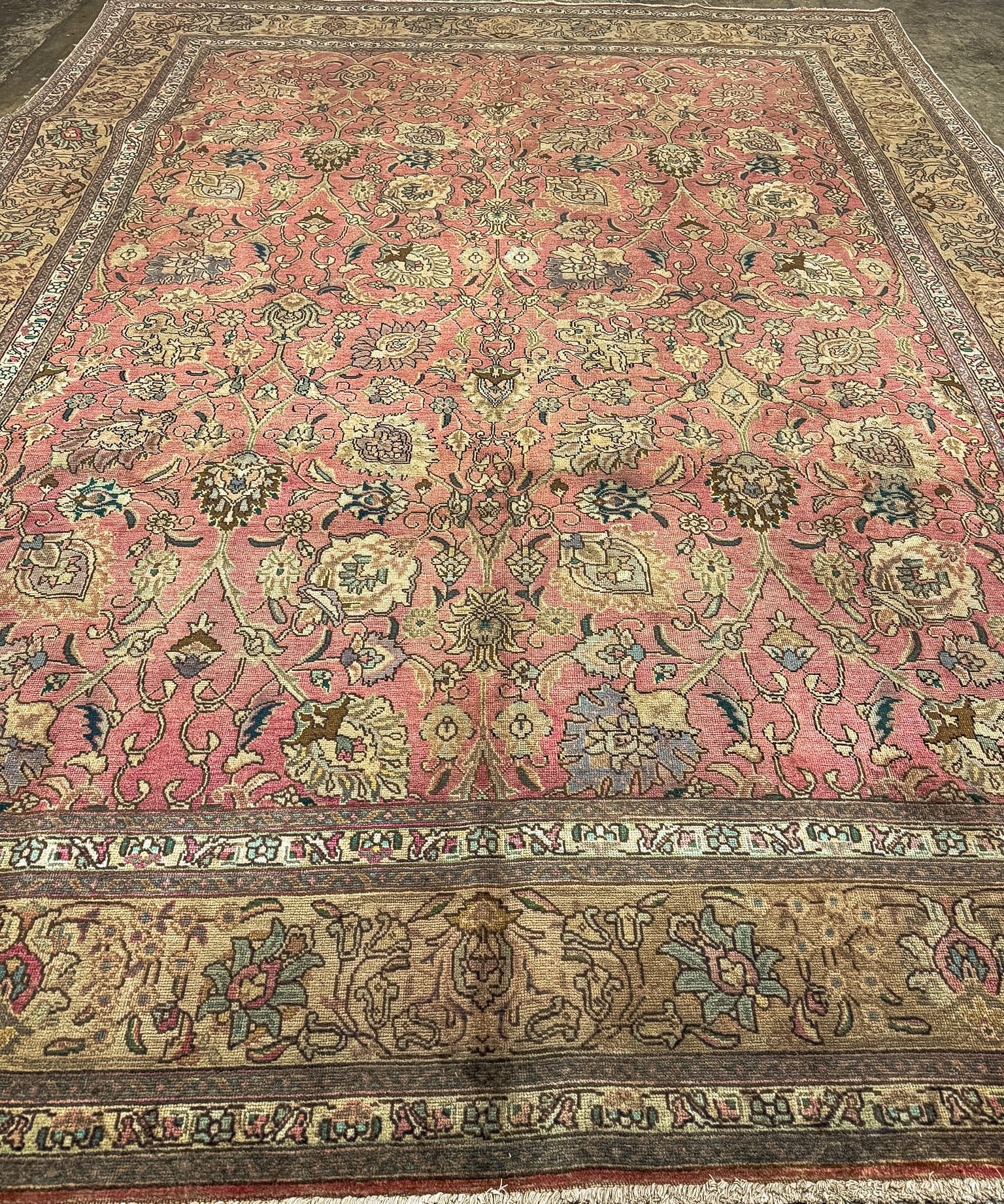 Rectangular Persian Tabriz rug with coral red floral motifs and wide ornamental border