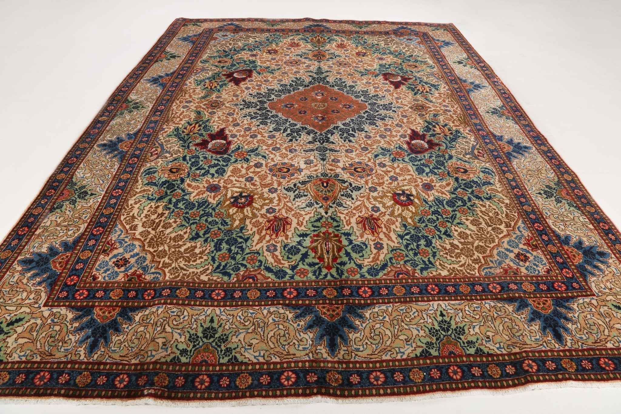 Tabriz rug flat-lay view with central medallion and ornate border in multicolor
