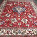 Persian Tabriz rug, red central field with pale border and ornate blue floral scrolls