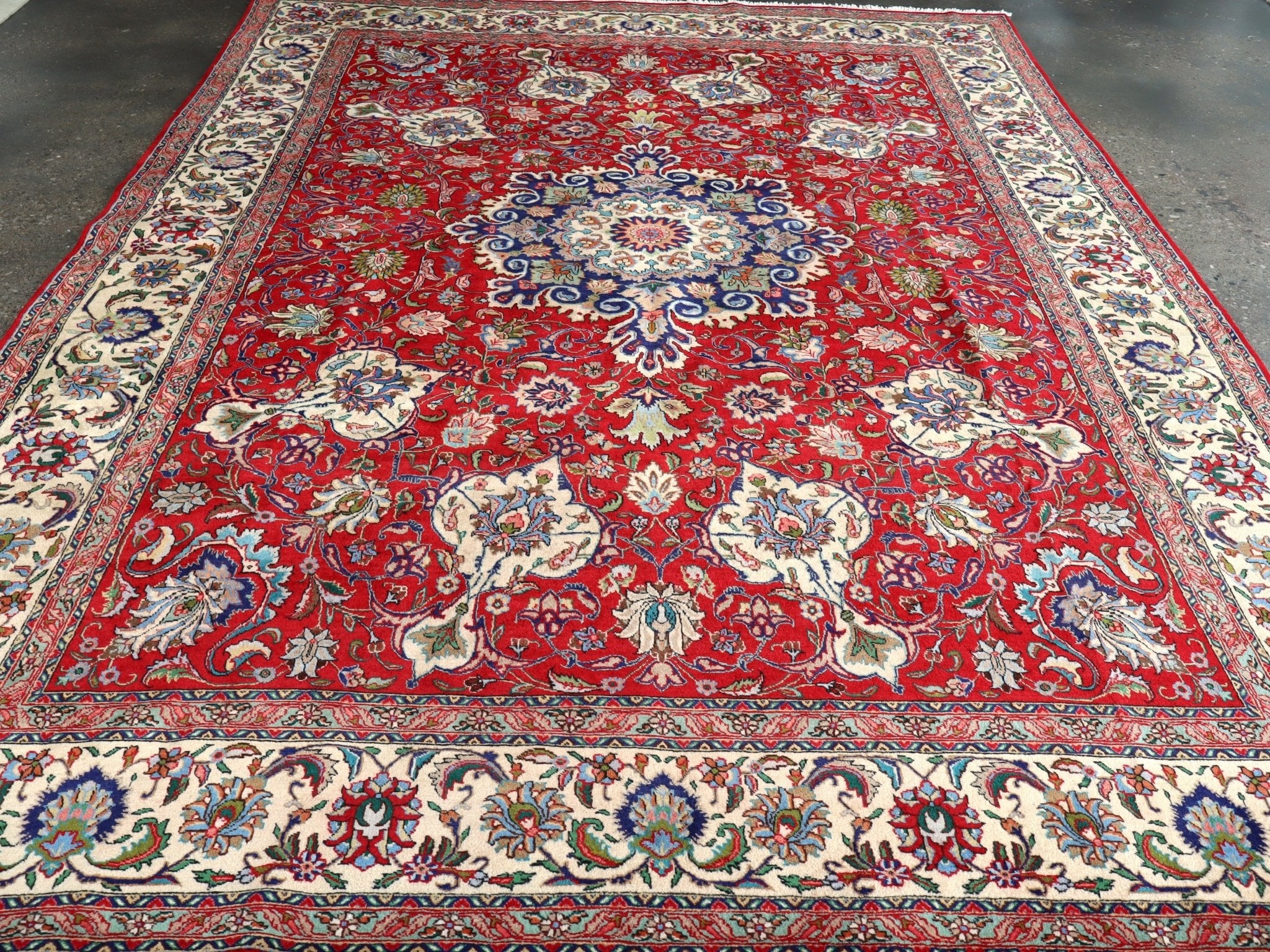 Persian Tabriz rug, red central field with pale border and ornate blue floral scrolls