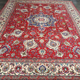 Persian Tabriz rug, red central field with pale border and ornate blue floral scrolls