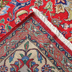 Persian Tabriz rug corner view with fringed cream edge and red-blue geometric border