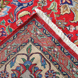 Persian Tabriz rug corner view with fringed cream edge and red-blue geometric border