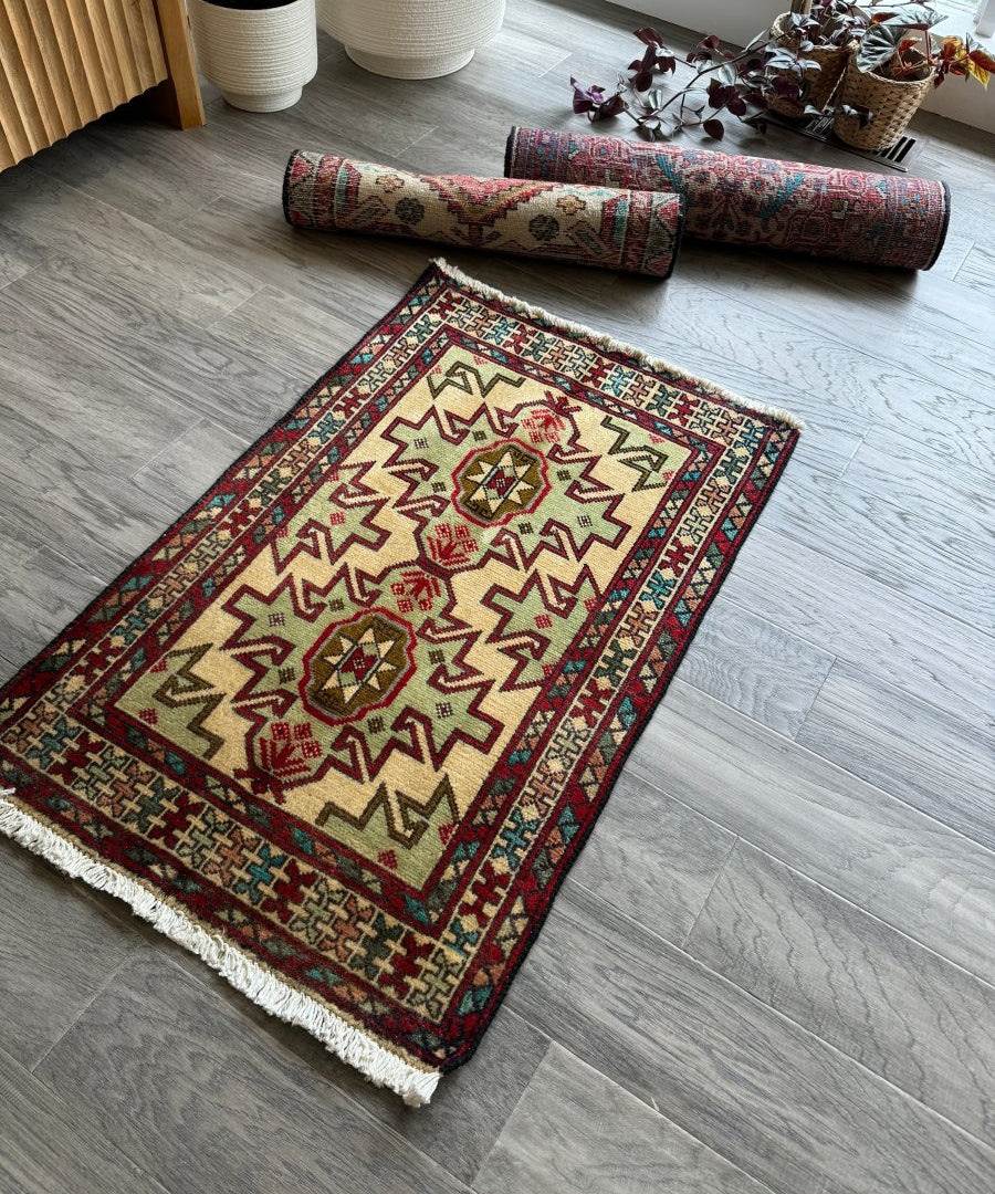 Persian Turkomana rug, cream center with red, blue, and green geometric diamond pattern