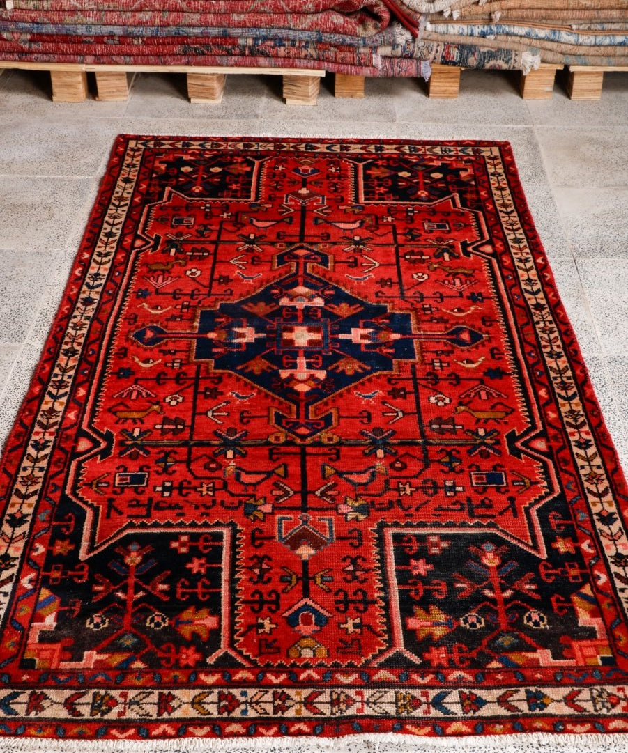 Tuyserkan Persian rug with red field and blue central medallion, ornate border