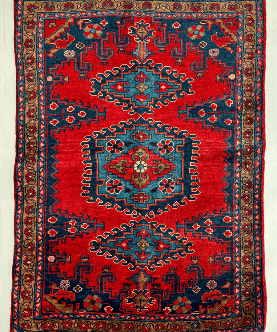 Persian Viss rug with red center medallion, navy border, and geometric motif pattern