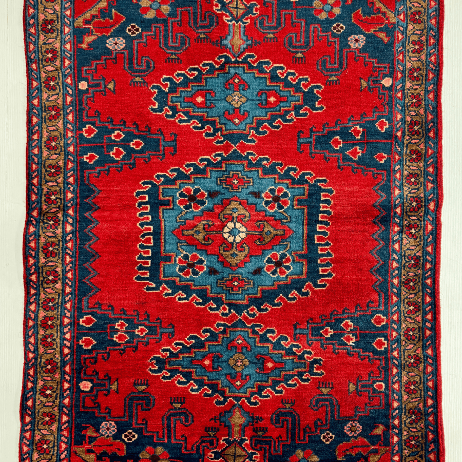Persian Viss rug with red center medallion, navy border, and geometric motif pattern