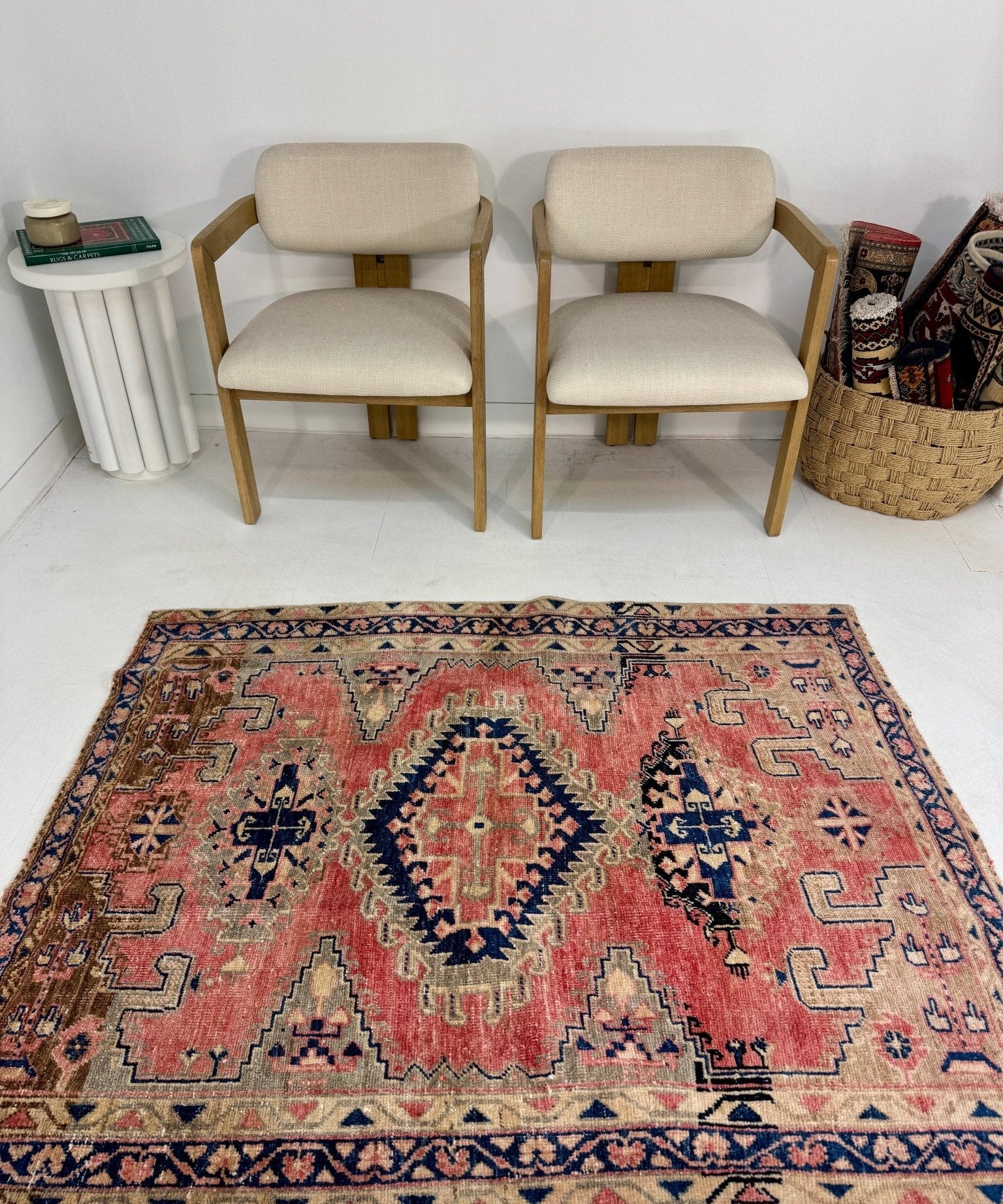 Area rug with red, blue, and cream geometric medallion pattern border.