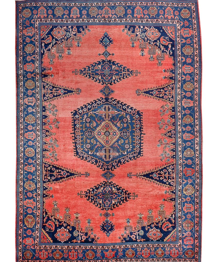 Persian Viss rug with coral red background, navy blue geometric border and motifs