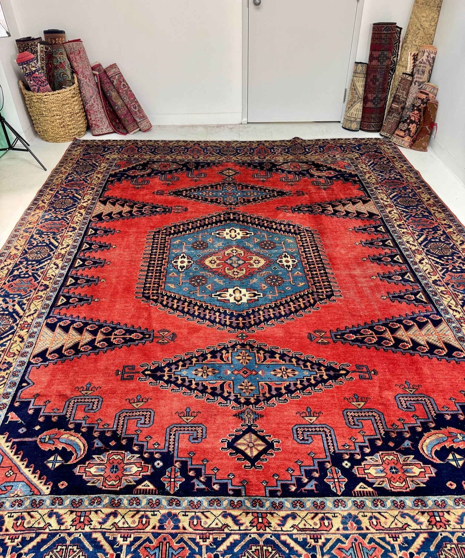 Persian Viss rug with large medallion, red background, and blue corner motifs