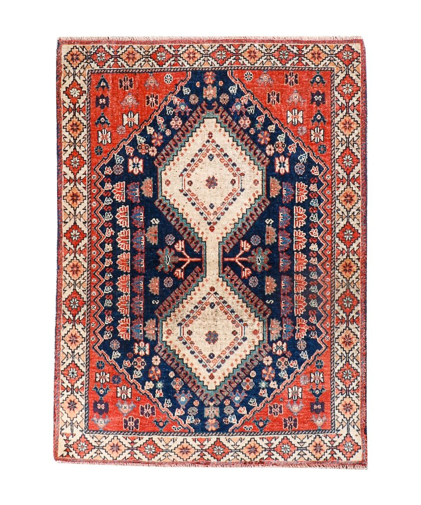 Persian Yalameh rug with navy and red field, cream diamond medallion, ornate border