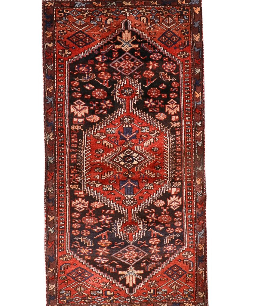 Persian Zanjan style rug with dark red, black, and cream geometric medallion patterns