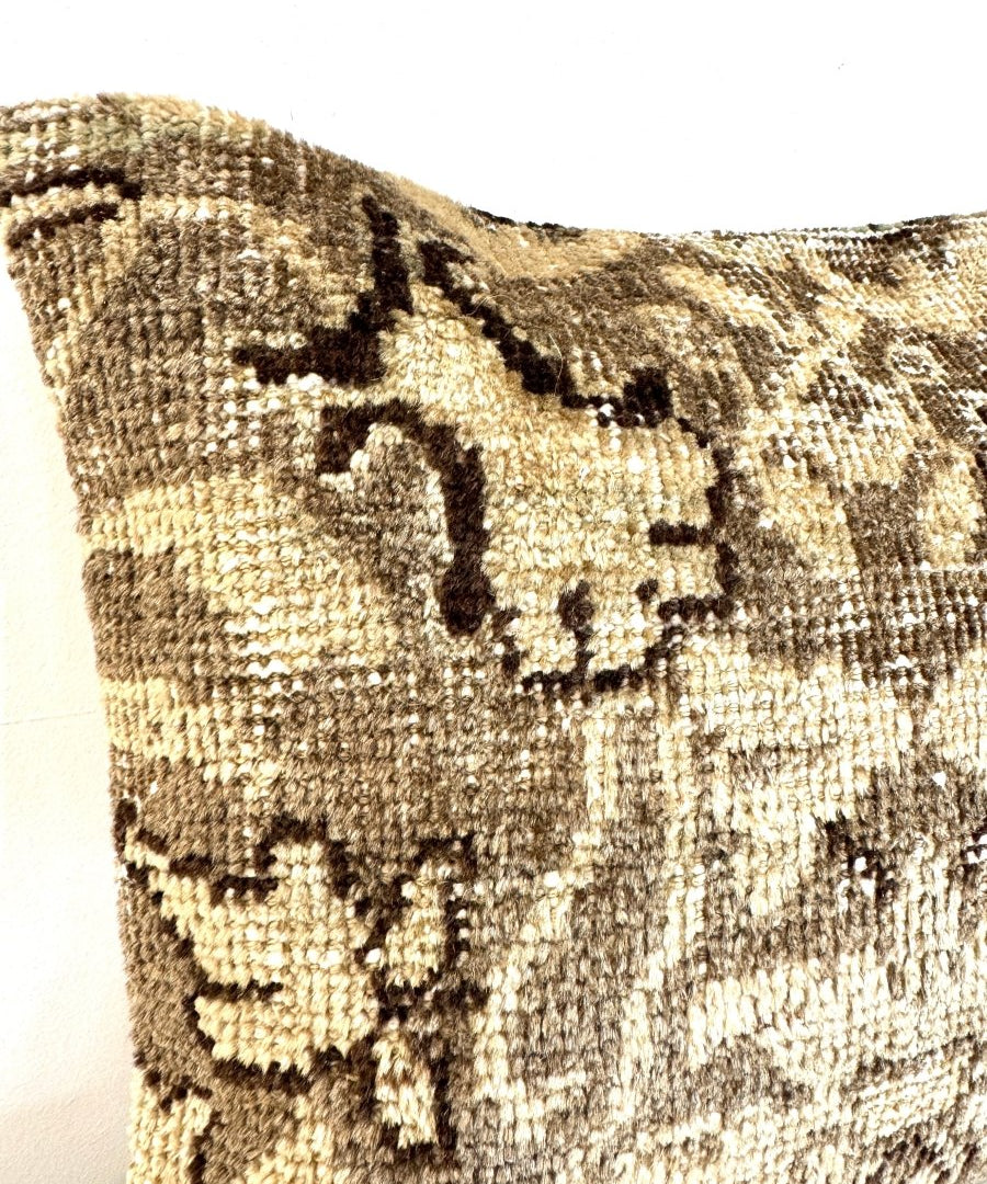 Close-up of beige and dark patterned woven pillow front panel