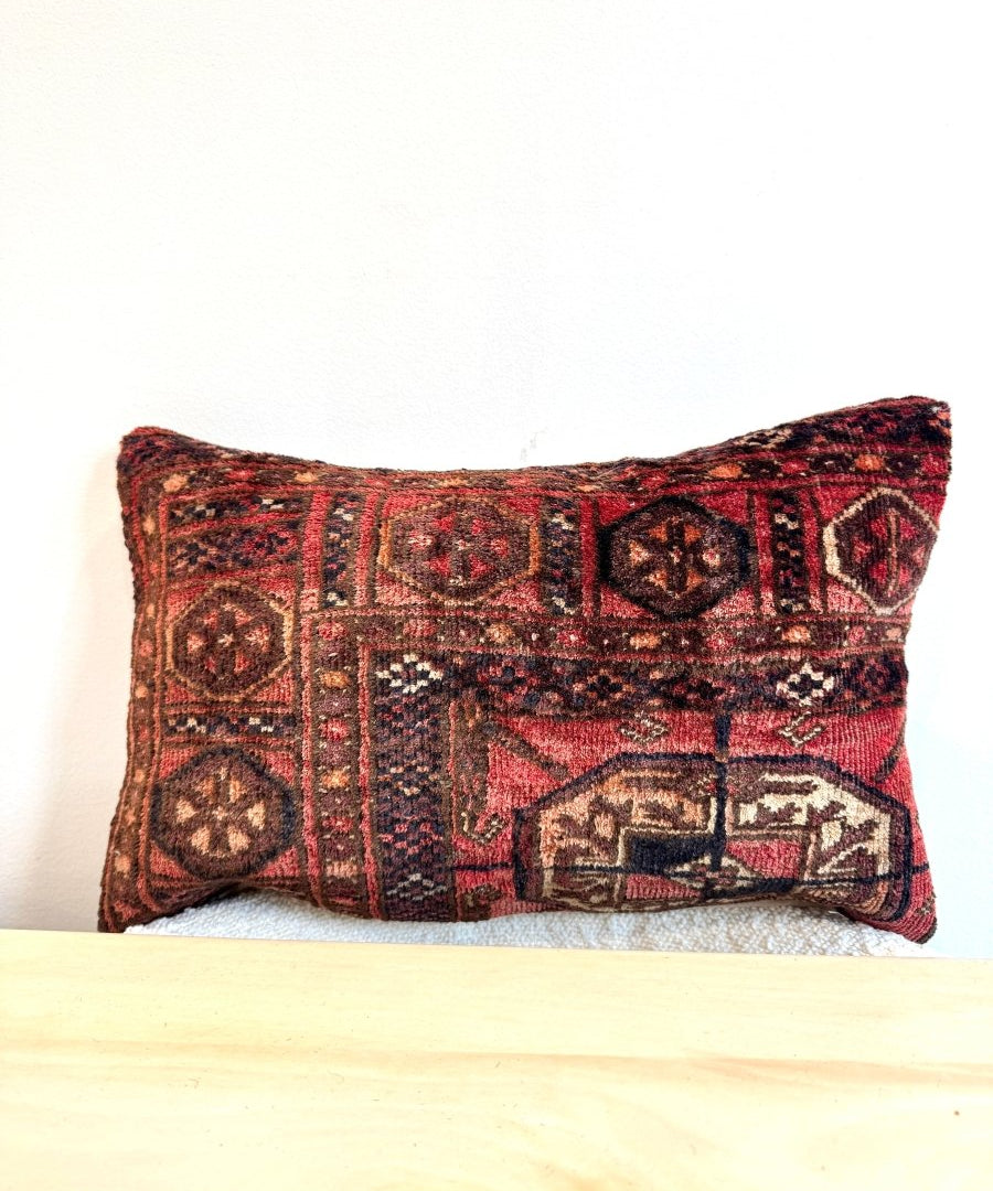 Decorative 12 x 18 inch pillow with red, black, and tan geometric woven pattern