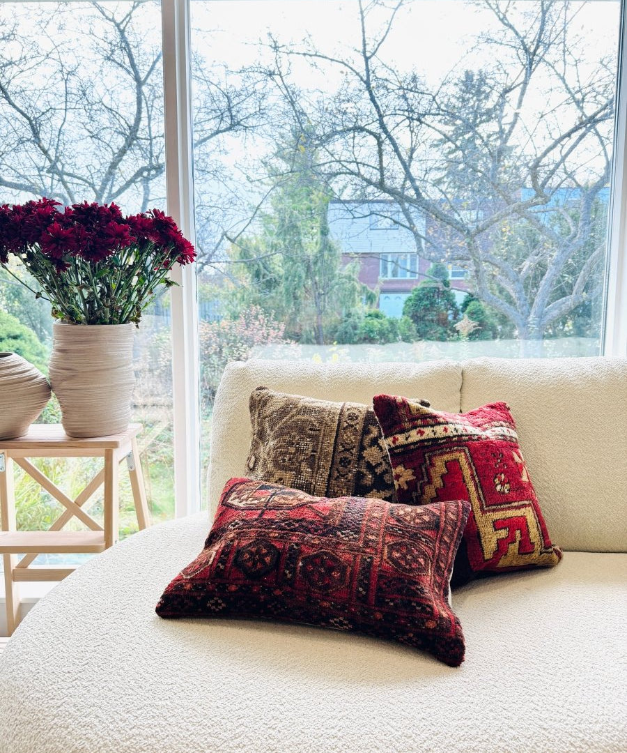 Set of 12 x 18 inch decorative pillows with red and dark multicolor patterned covers