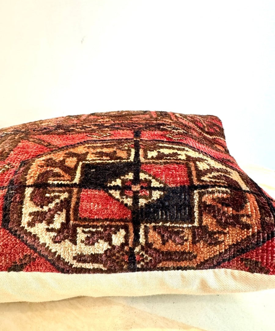 12 x 18 inch decorative pillow angled view with red, black, and cream geometric pattern