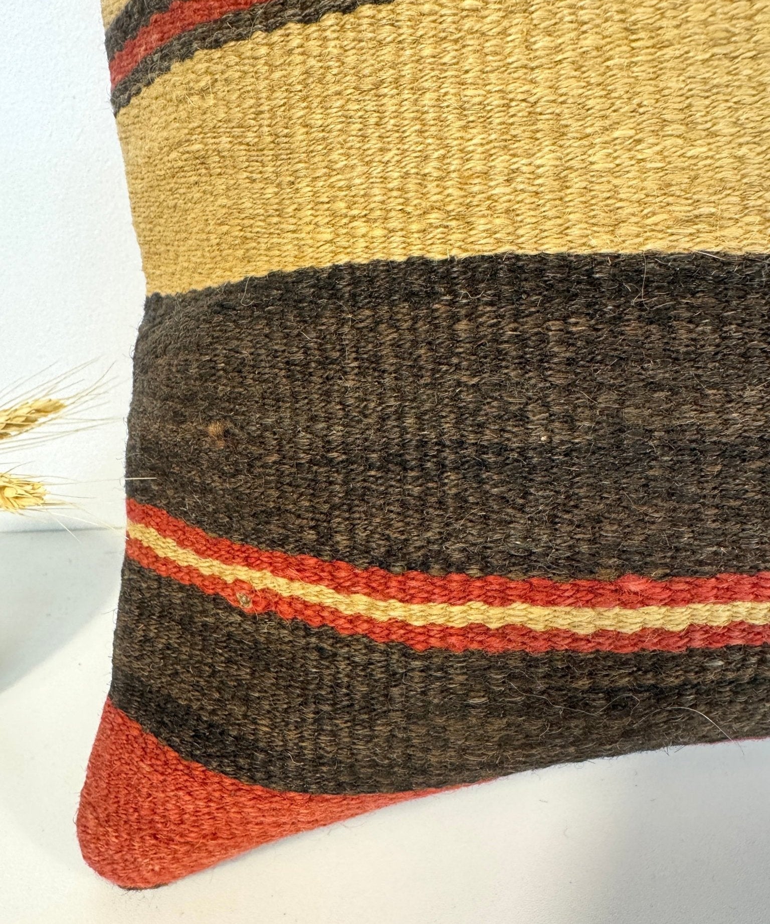 Striped pillow corner detail, mustard yellow and dark gray horizontal stripes