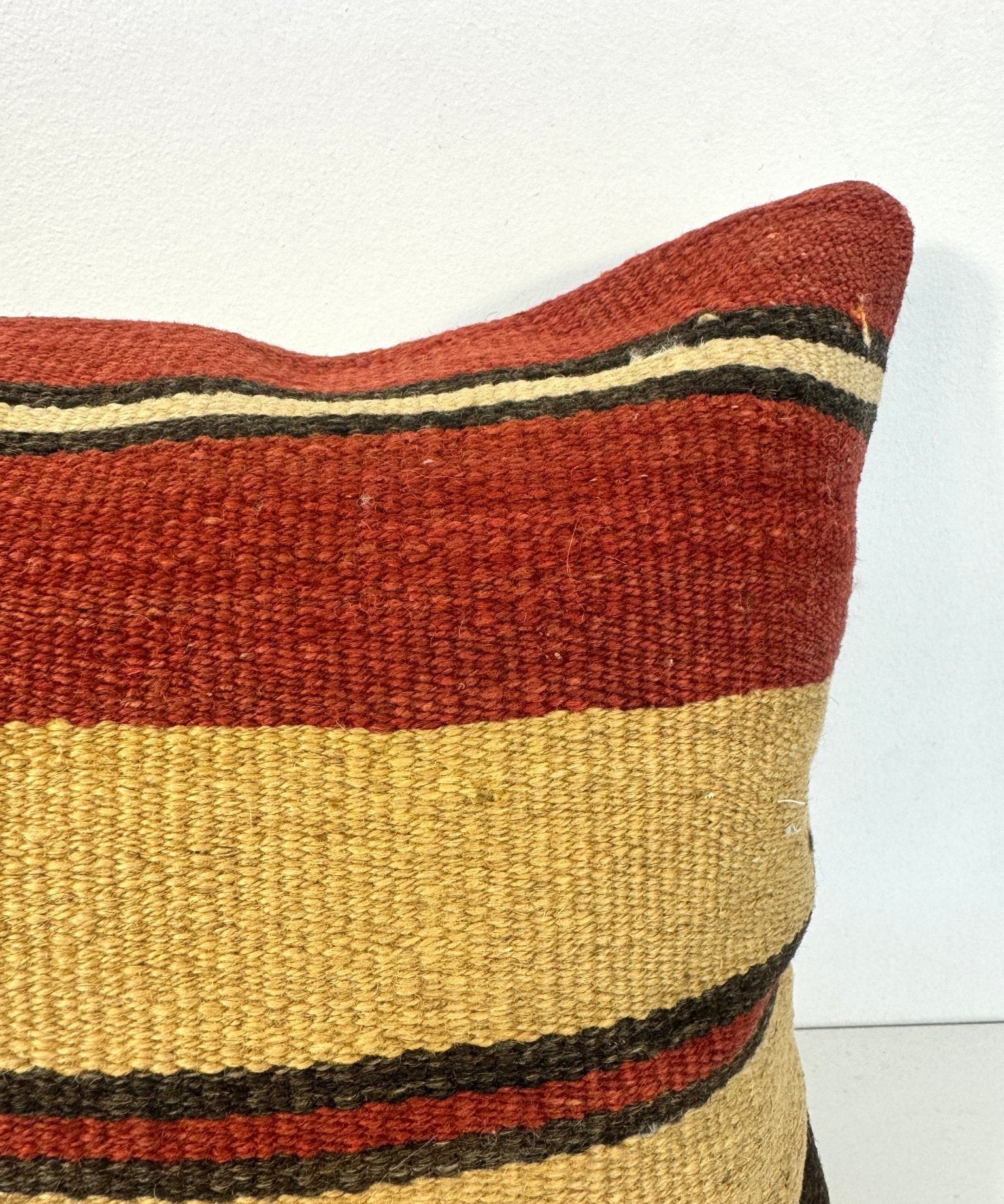 Striped 16x16 pillow close-up, red and yellow bands with dark gray stripes