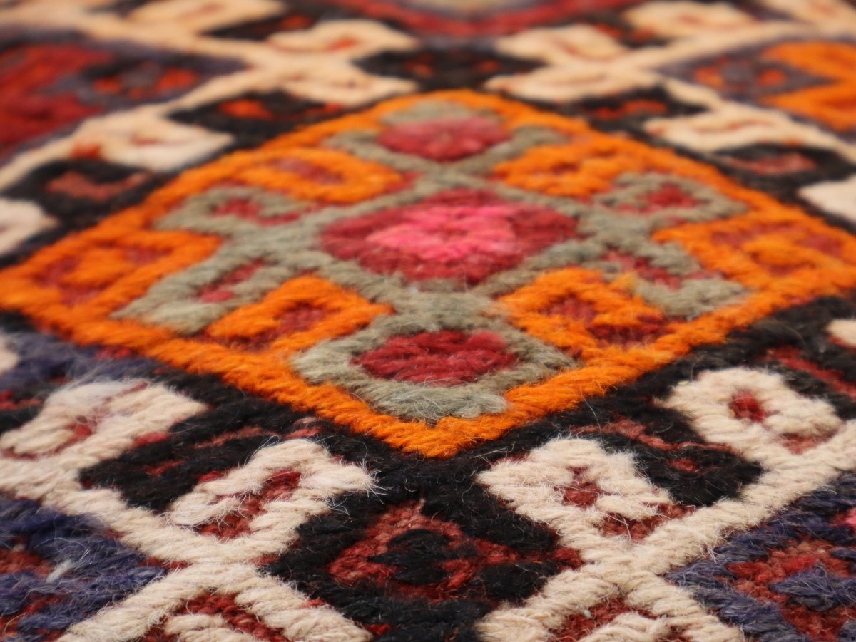 Geometric patterned pillow cover with orange, red, black, and cream motifs, 16 x 16 in