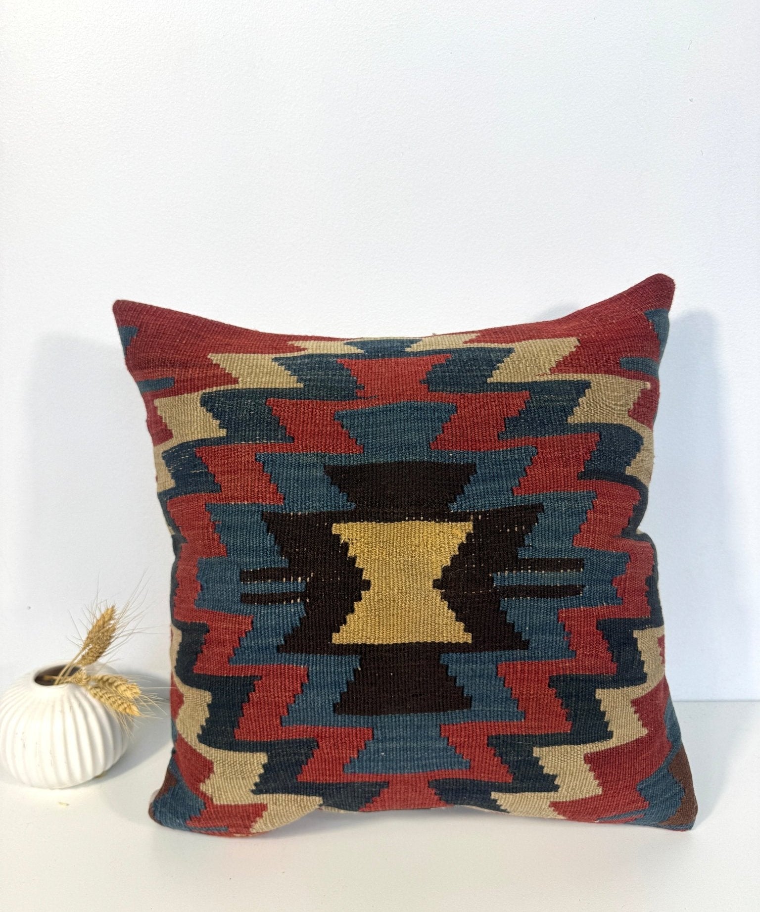 16 x 16 decorative pillow with bold geometric zigzag pattern and tasseled corners.