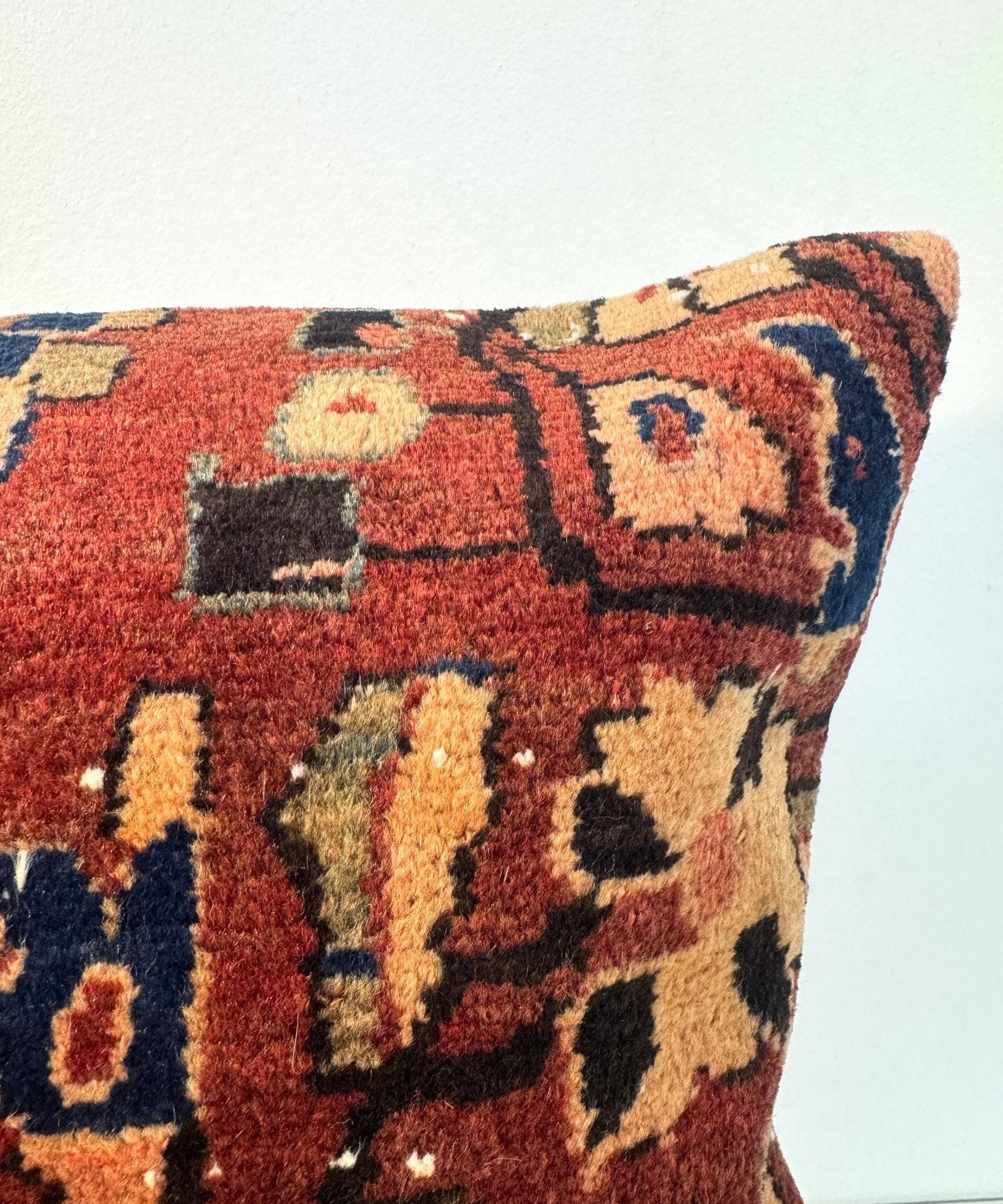 16x16 woven pillow front detail with burgundy base and multicolor geometric motifs