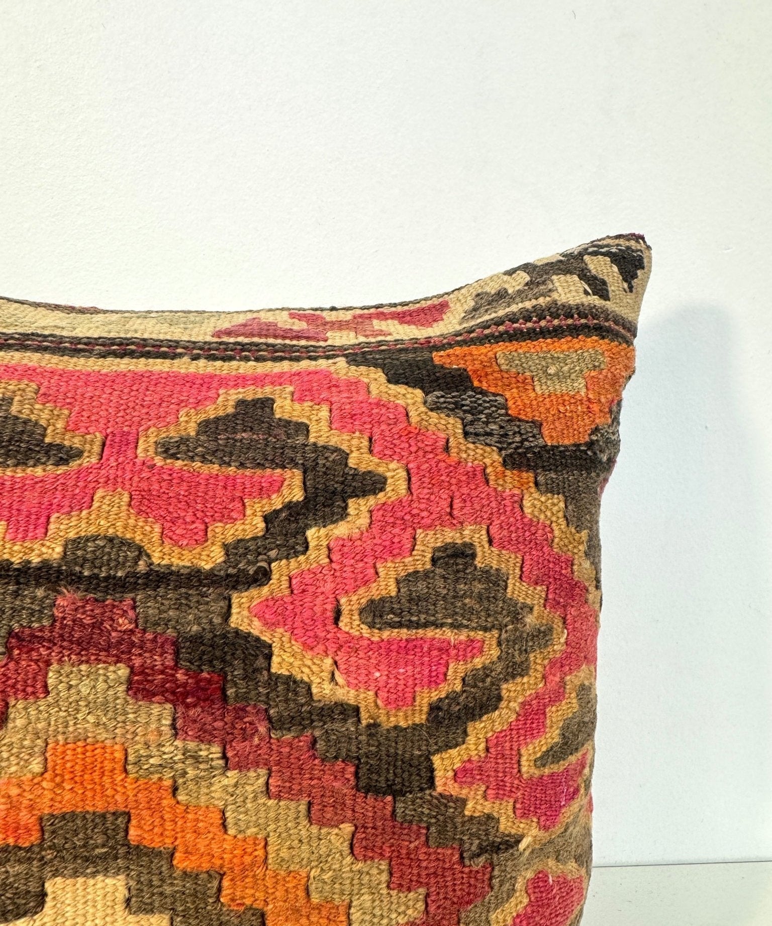 Geometric kilim throw pillow cover with multicolor diamond pattern, dark border.