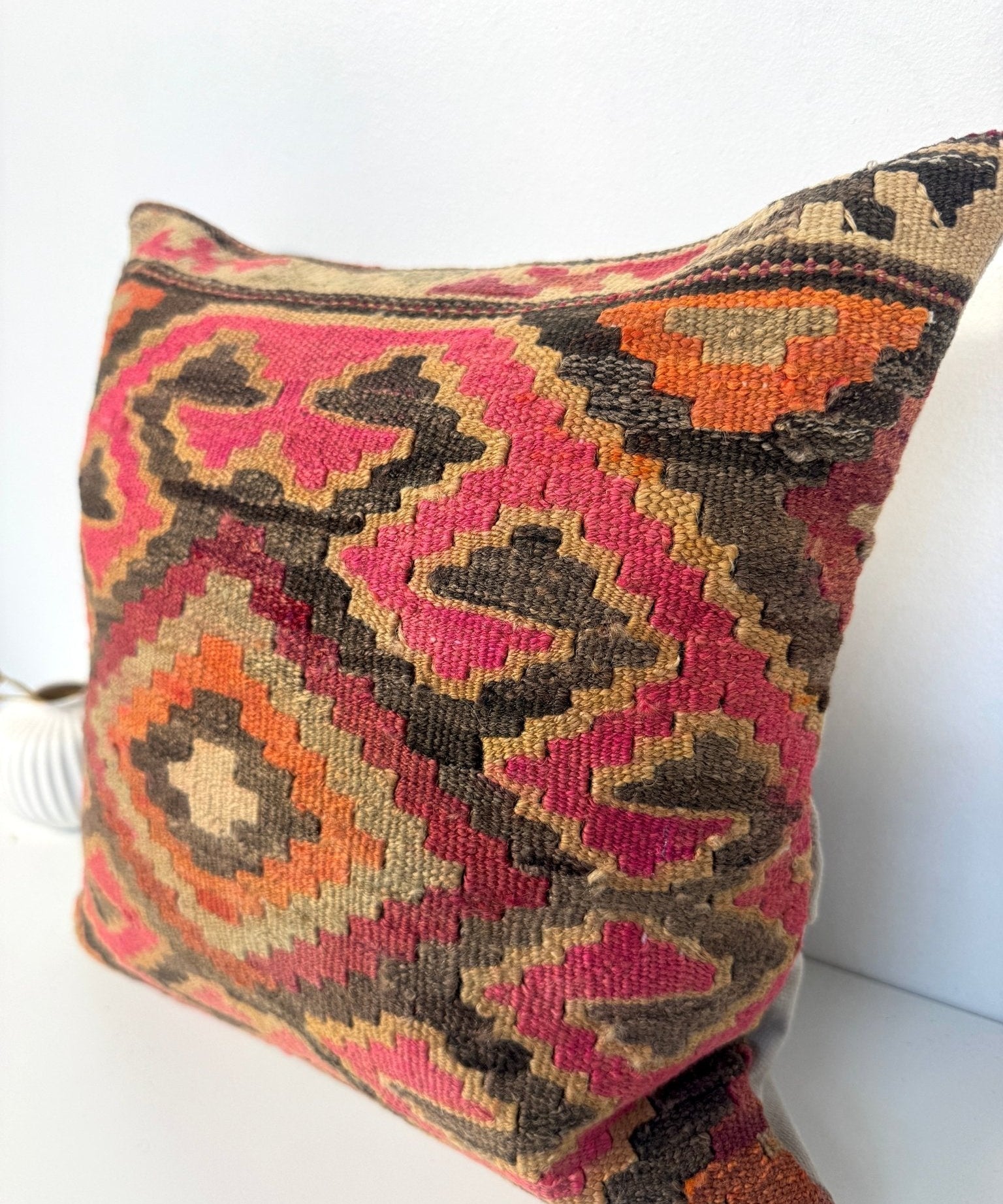 Multicolor kilim pillow cover with large central diamond pattern and dark frame edge.