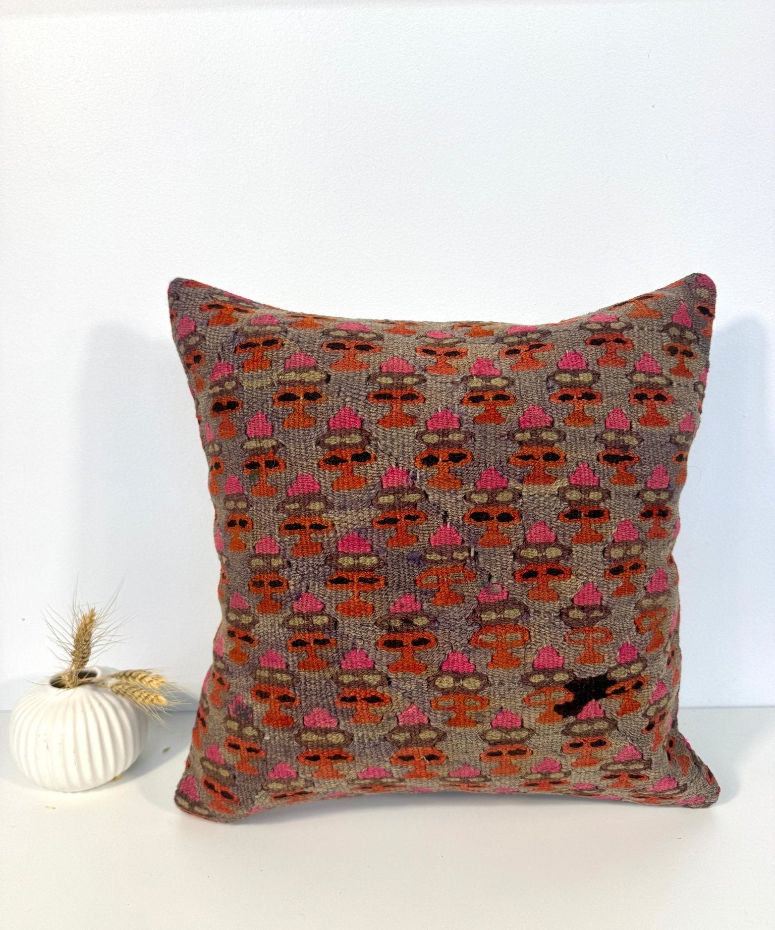 16x16 square decorative pillow with multicolor stitched geometric pattern on gray base
