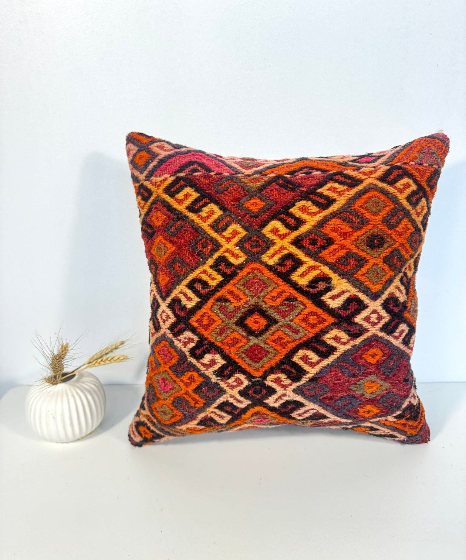 16 x 16 multicolor geometric patterned throw pillow with matching diamond motifs on front