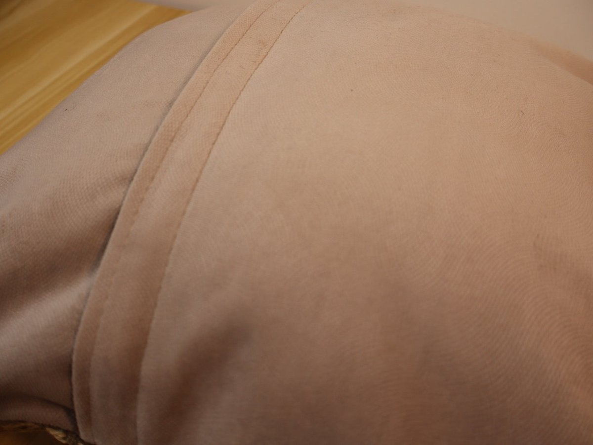 Beige fabric pillow back with smooth seam and piping detail