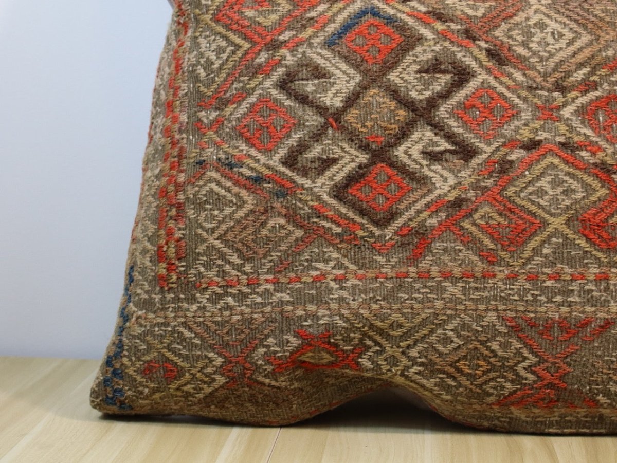 Multicolor woven pillow cover close-up with geometric diamonds and border trim