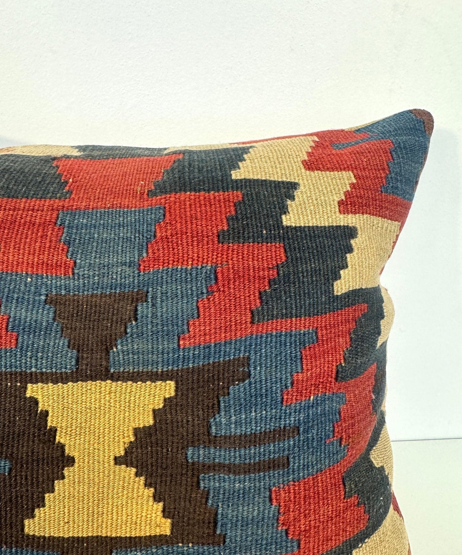 16 x 16 in decorative pillow cover with bold geometric pattern in red, blue, and yellow