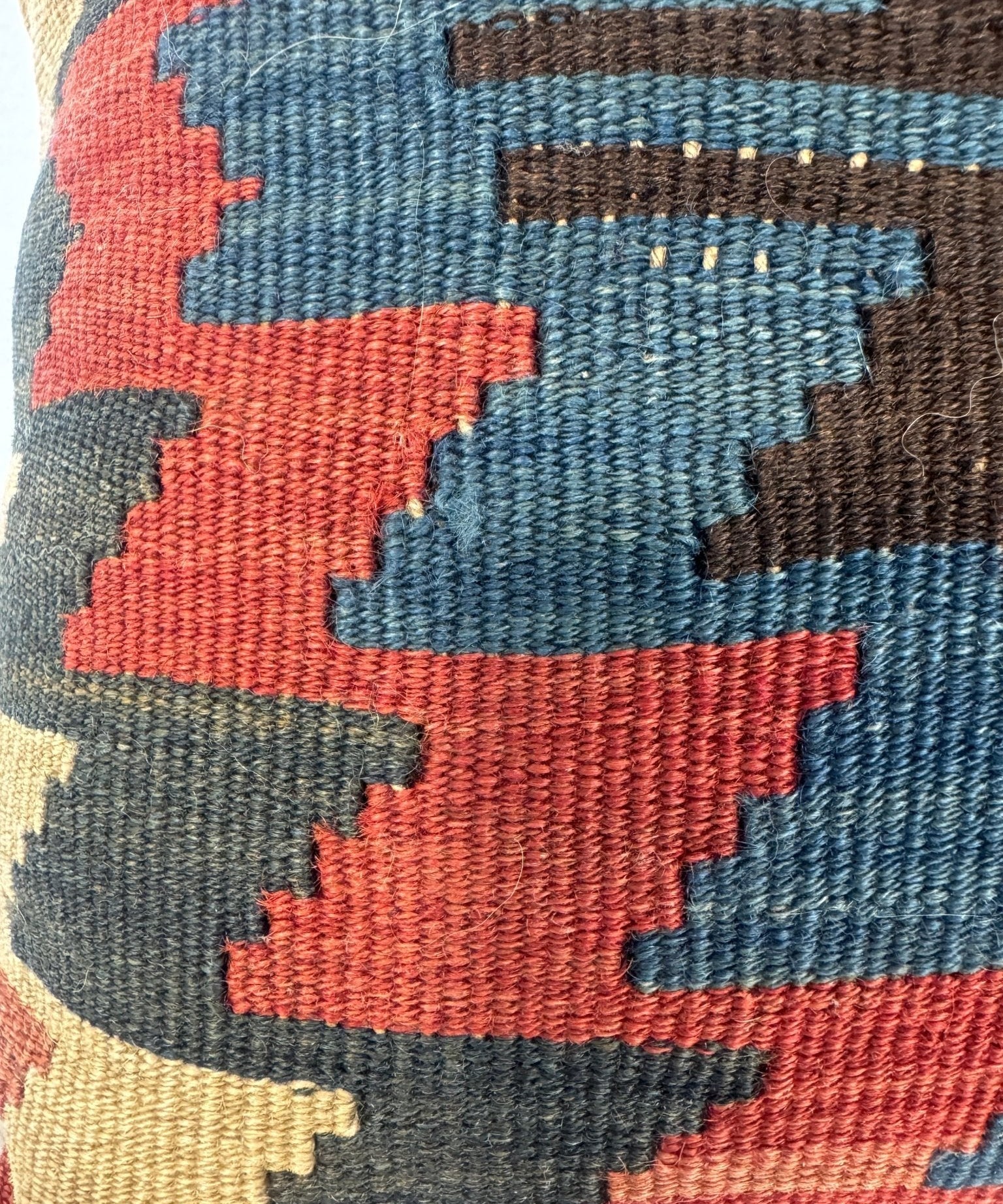 16 x 16 in decorative pillow close-up of woven geometric blocks in teal, red, and cream