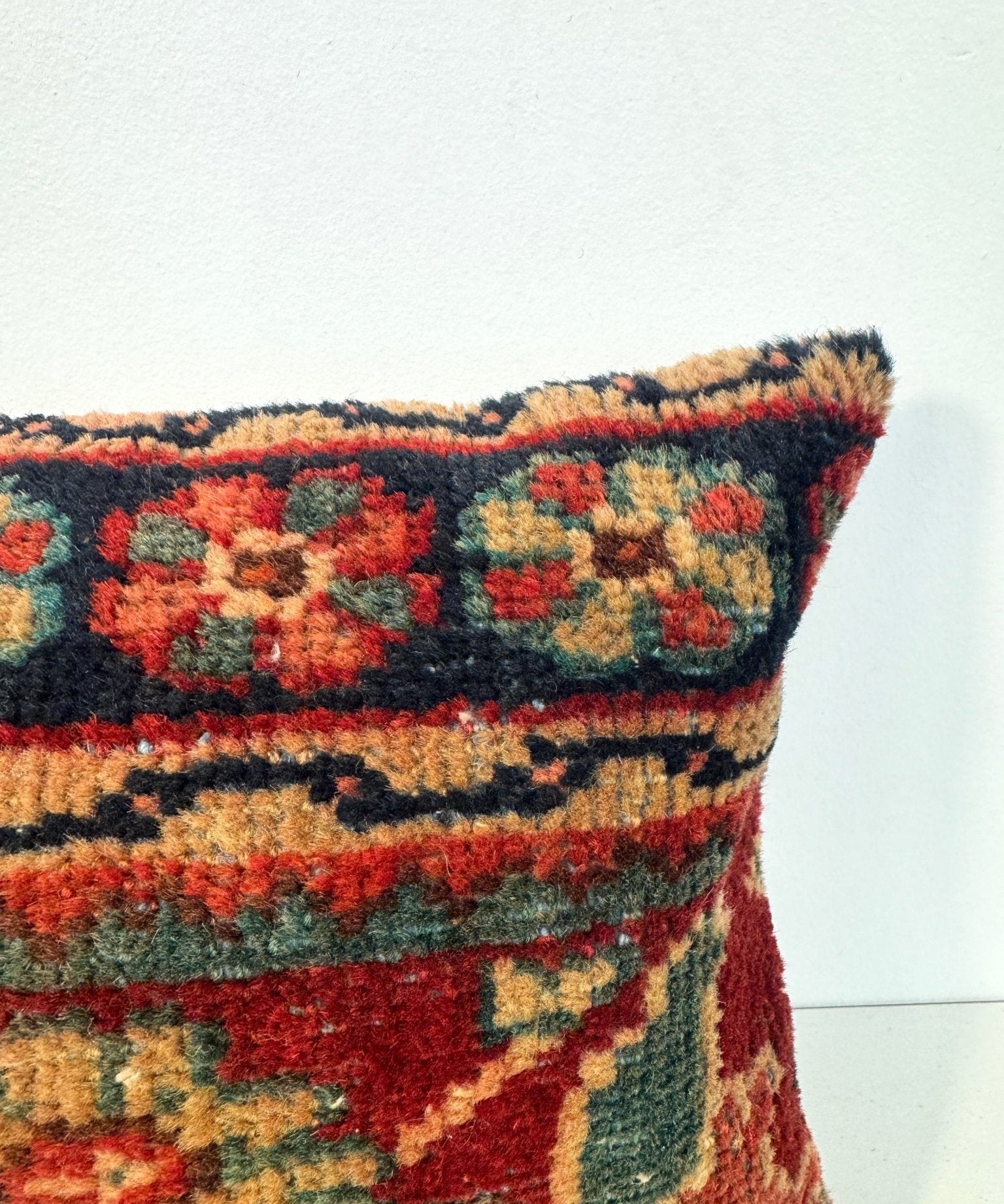 Pillow cover corner showing woven geometric pattern with dark navy border trim