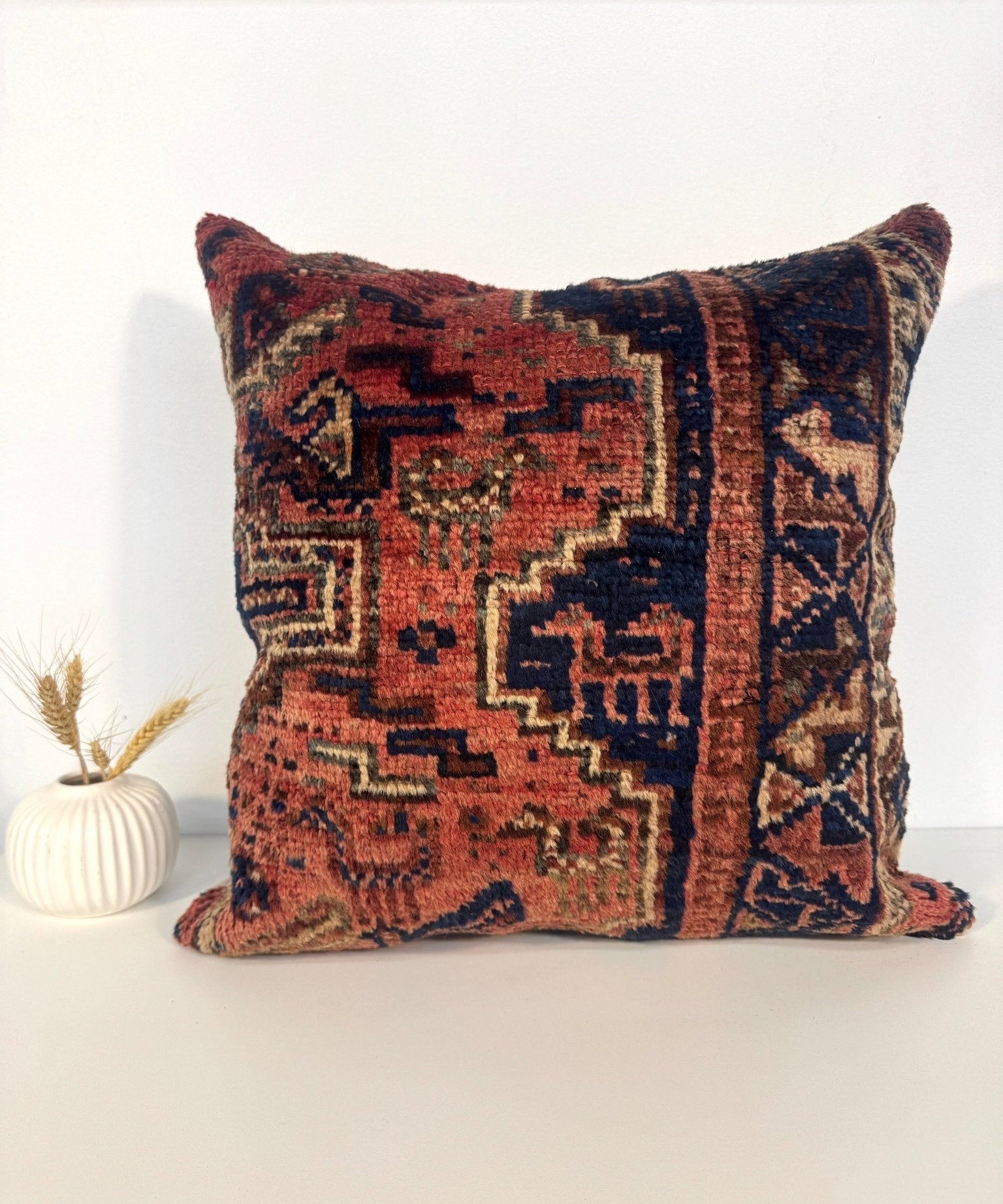Decorative 18x18 pillow with multicolor geometric front and off-white backing