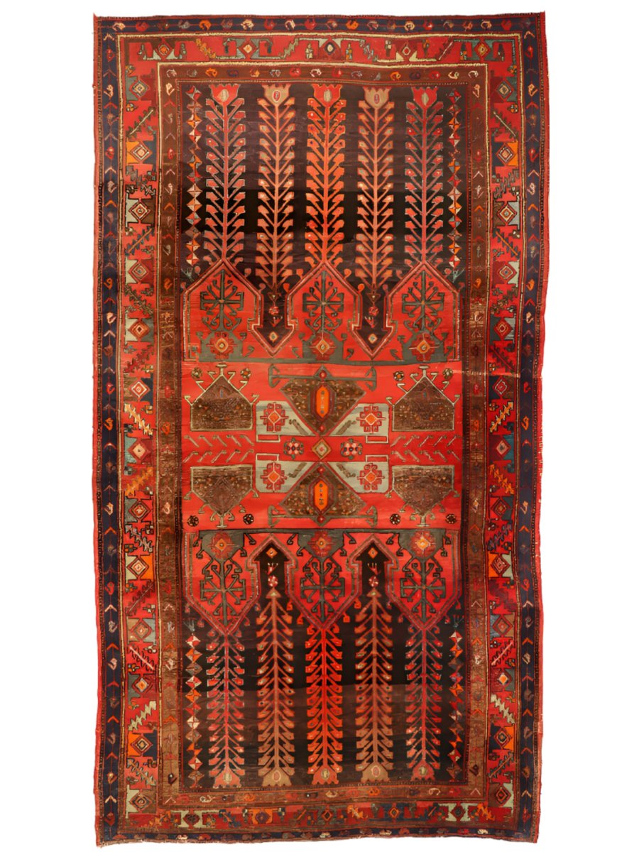Vintage geometric area rug with red background, navy accents, and central medallion design