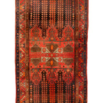 Vintage geometric area rug with red background, navy accents, and central medallion design