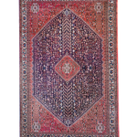 Full view Persian-style rug with red border, navy center, and diamond medallion
