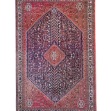 Full view Persian-style rug with red border, navy center, and diamond medallion