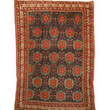 Antique Afshar rug flat view: dark blue, red and green diamond motifs with cream border