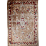Ivory Tabriz-style area rug with red and blue corner ornaments and center medallion.