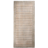 Rectangular beige paisley rug with central field of repeating motifs and patterned border