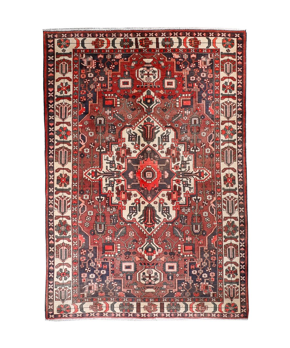 Persian Bakhtiar rug full view with red field, cream border, and ornate geometric center