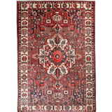 Persian Bakhtiar rug full view with red field, cream border, and ornate geometric center