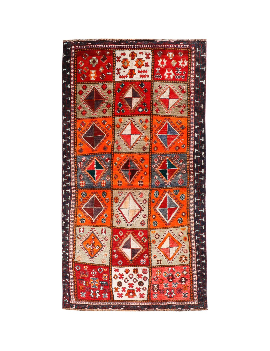 Persian Shiraz rug with red-orange field, cream diamonds, navy border and fringe.
