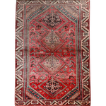 Persian Shiraz rug with red field and central medallion, teal and cream geometric pattern.
