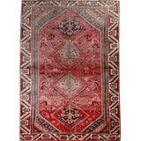 Persian Shiraz rug with red field and central medallion, teal and cream geometric pattern.